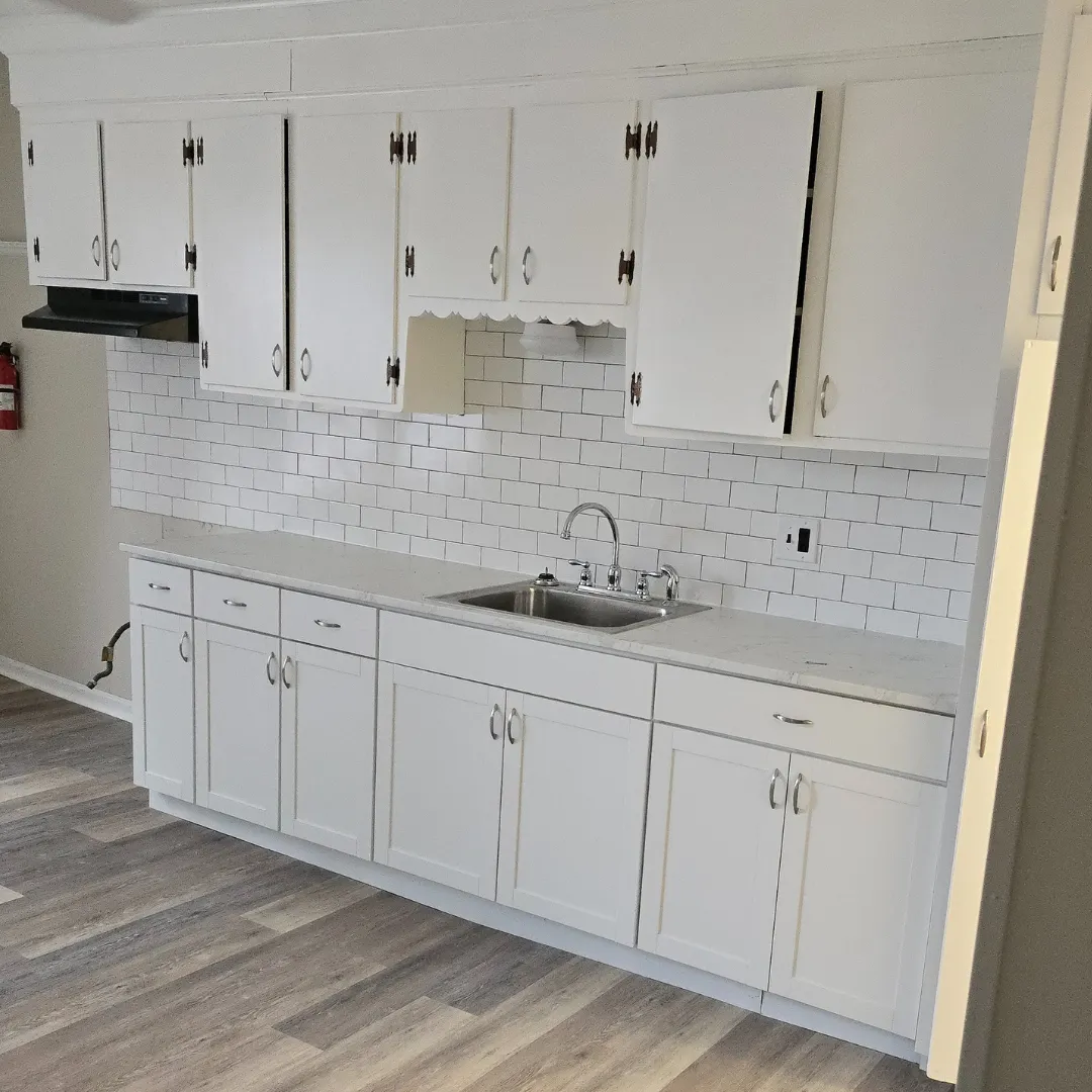 Repainted white kitchen cabinets with white subway tile backsplash by Link Services Pro in Shrewsbury, MA