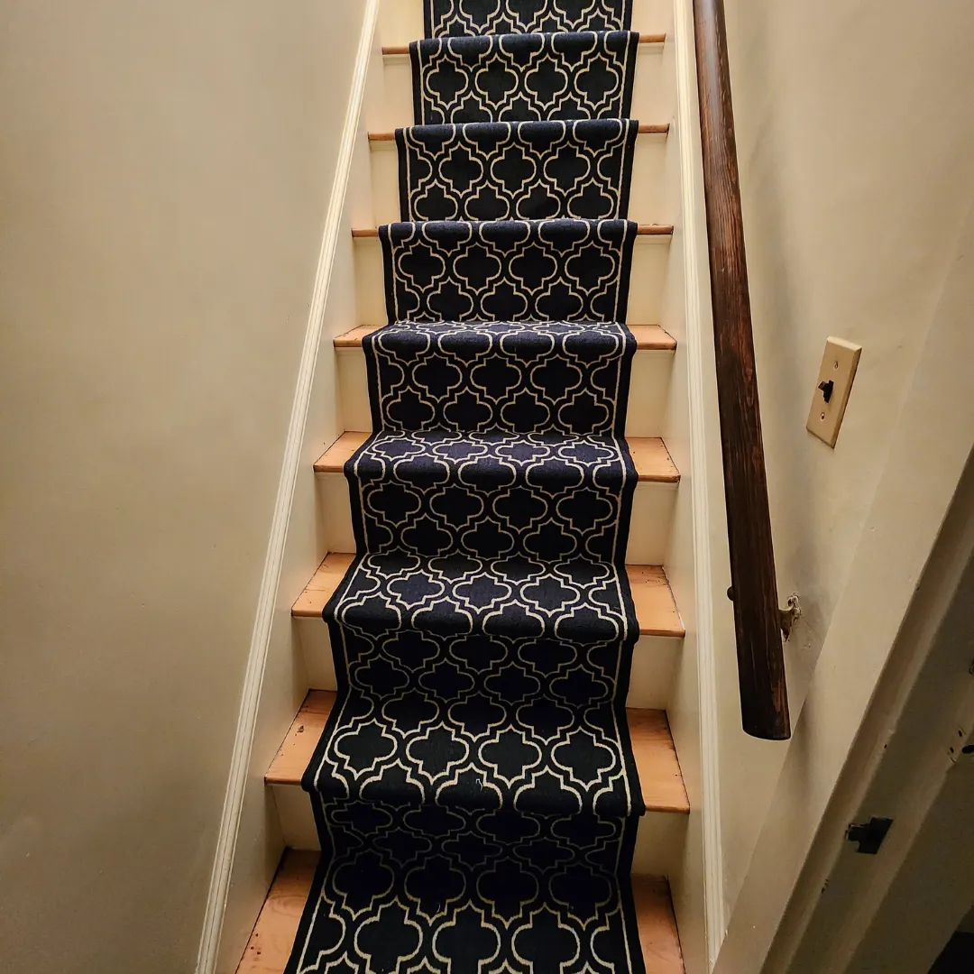 Patterned navy stair runner installed on wood treads by Link Services Pro in Holden, MA