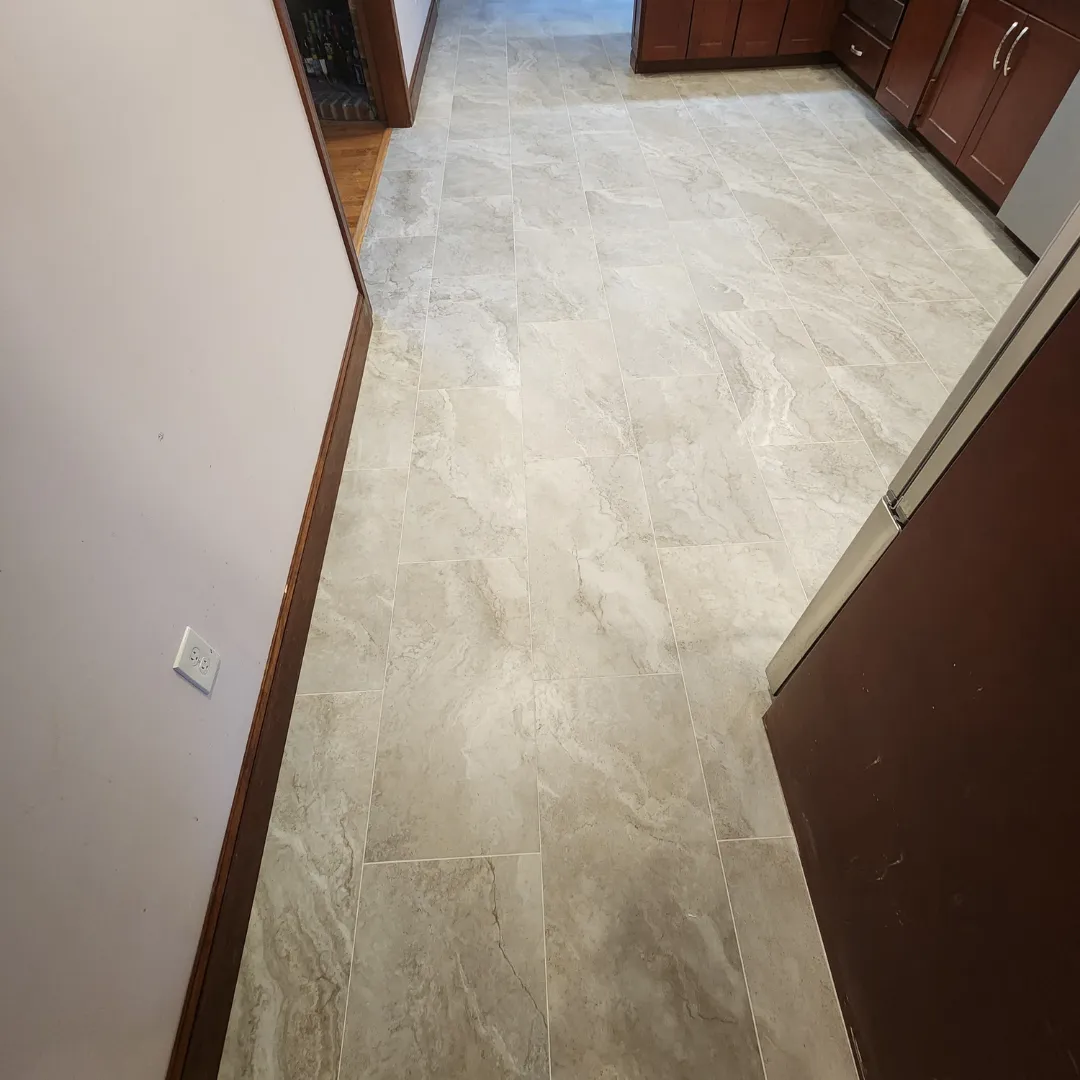 Large-format porcelain tile floor with stone-look pattern in hallway by Link Services Pro in Millbury, MA