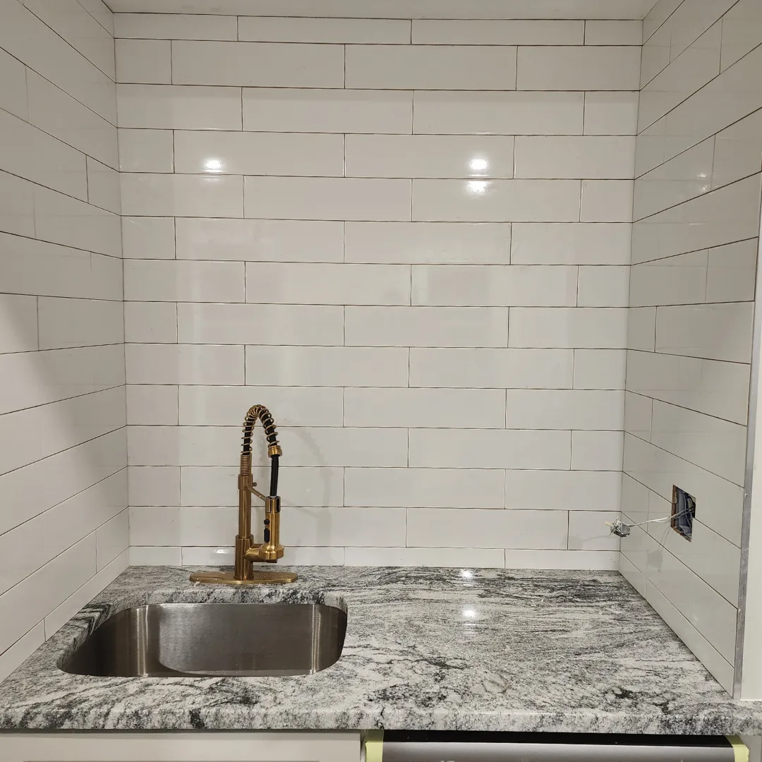 Wet bar with white subway tile and viscount granite countertop by Link Services Pro in Worcester, MA