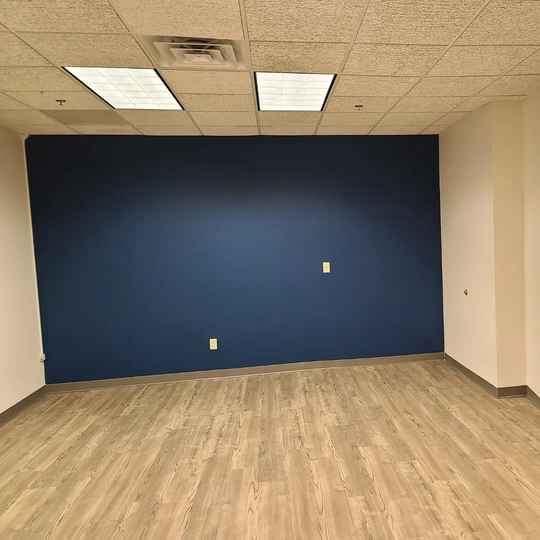 Office accent wall painted navy blue with luxury vinyl plank flooring by Link Services Pro in Holden, MA