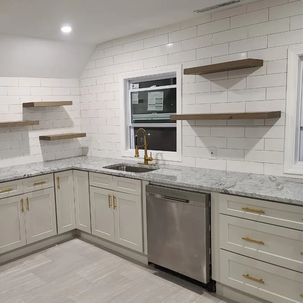Modern kitchen with white subway tile, floating walnut shelves and granite counters by Link Services Pro in Worcester, MA